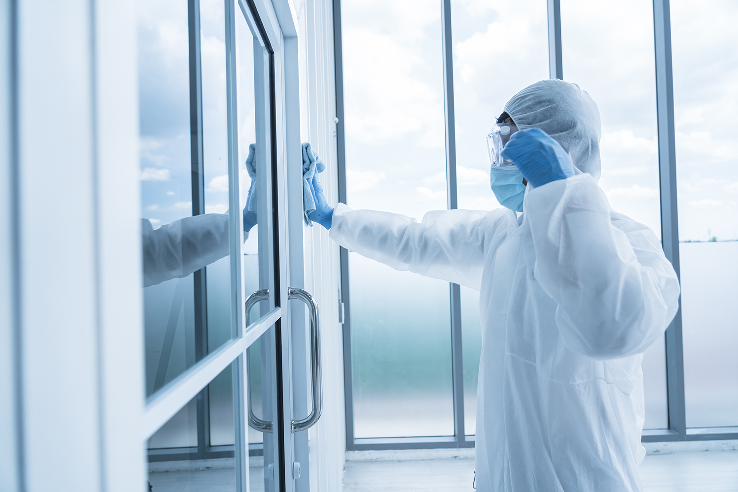a healthcare worker in PPE enters a highly contagious unit of a hospital